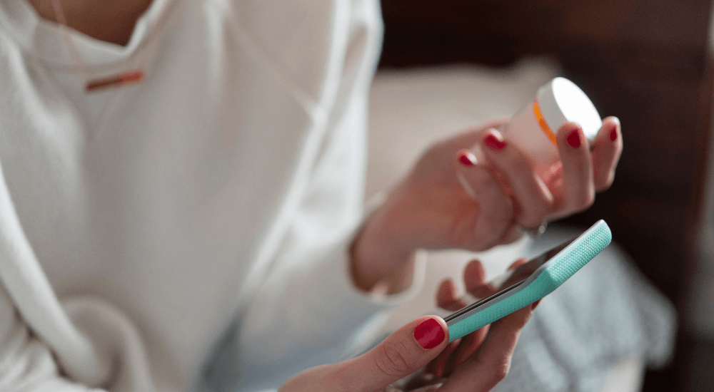 Person checking the details of their medication on their smartphone
